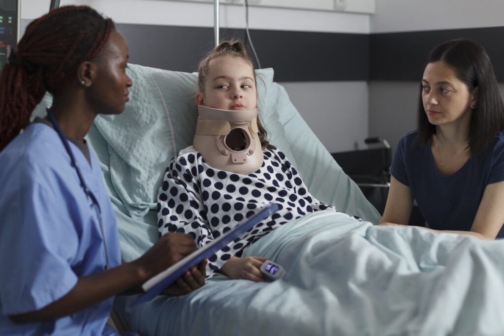 nurse examining injured girl with fractured neck