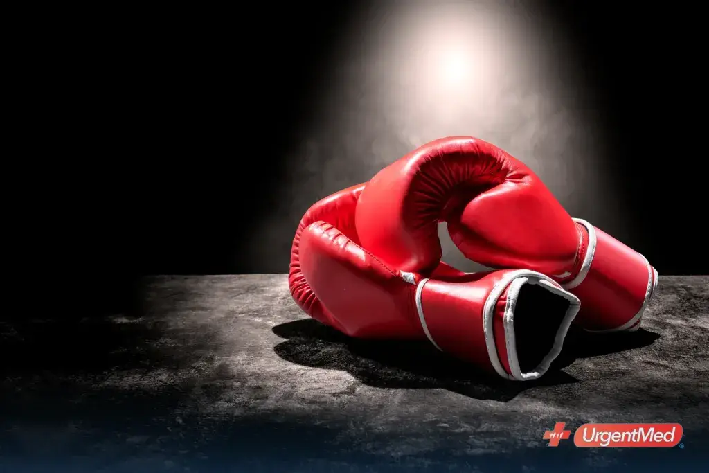 Pair of red boxing gloves under ring lights
