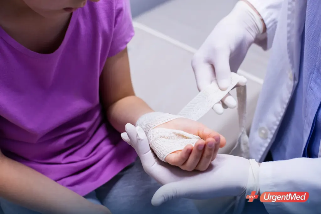 Provider bandaging a cut on a patient's hand