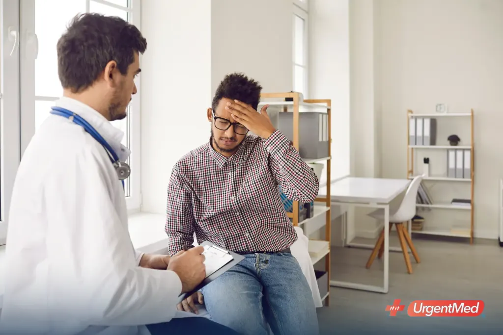 Provider examining a patient with cold and flu symptoms at an urgent care clinic
