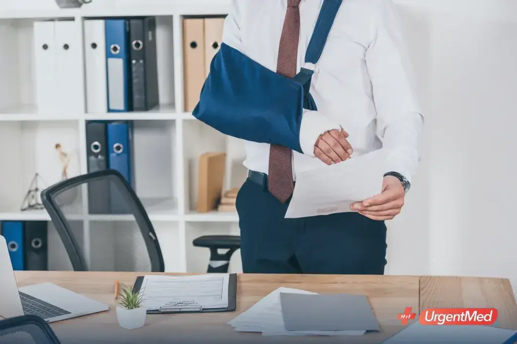 Injured worker with an arm sling reviewing workers' compensation paperwork