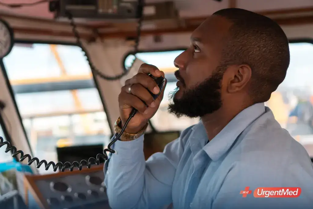 Mariner using the radio on the bridge of a vessel