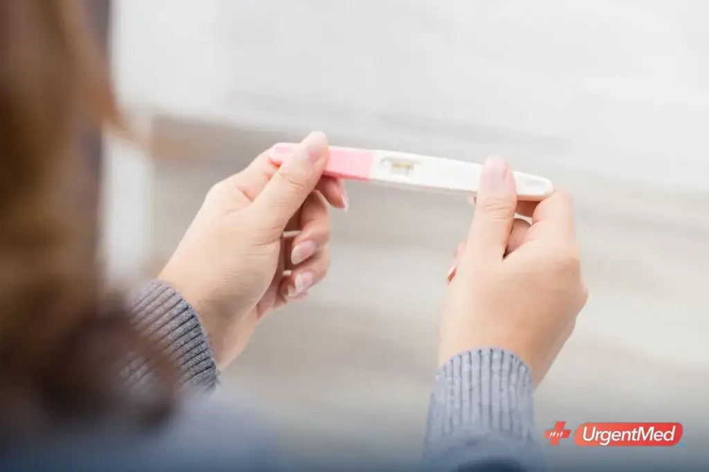 Woman holding a pregnancy test