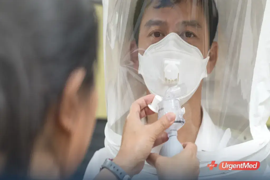 Employee wearing an N95 respirator under a fit-test hood