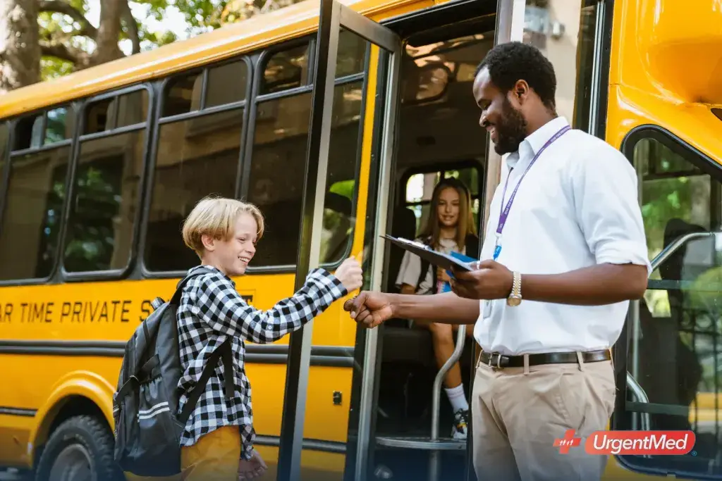 School bus driver checking a student onto a yellow school bus