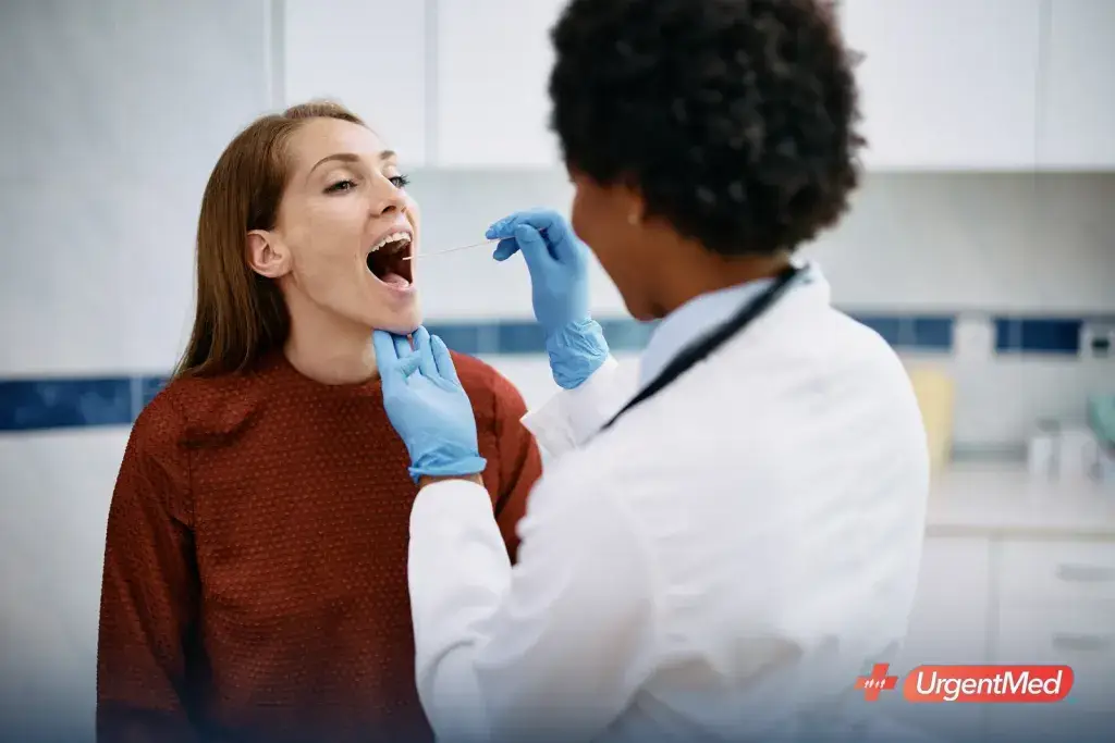 Provider examining a patient's throat for strep at an urgent care clinic