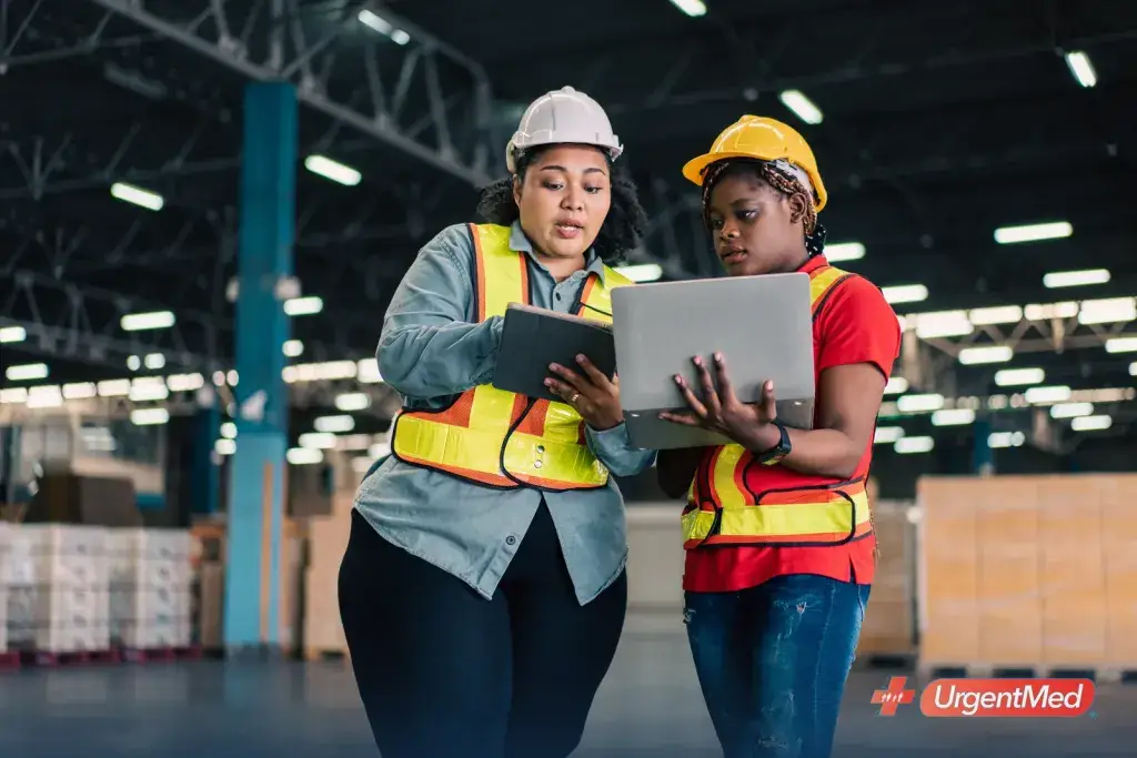 Manager reviewing a plan with an employee on the warehouse floor